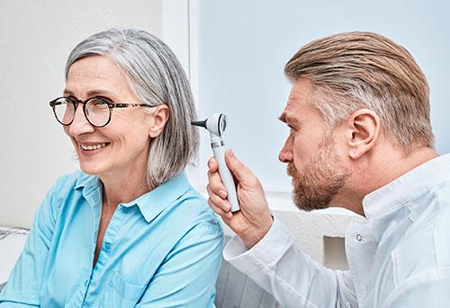 Audiologist Checking old lady ear